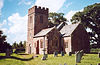 Red stone church with square tower.