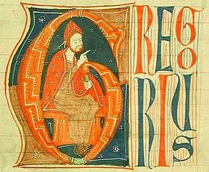 A bearded man in red robe confers benediction from a throne