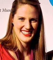 Head and shoulders photo of Missy Franklin, with shoulder-length hair and red blouse