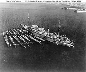 V-boats (left to right) Cachalot, Dolphin, Barracuda, Bass, Bonita, Nautilus, Narwhal, with submarine tender Holland