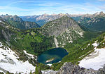 A lake and the surrounding mountains and forest viewed from Maple Pass.