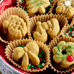 close up image of cookies in cupcake liners and an old fashioned cookie tin