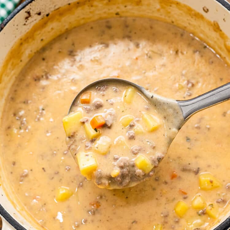 Ladle scooping Cheeseburger Soup out of pot