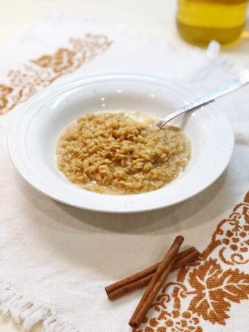 apple cider oatmeal in a bowl with a spoon