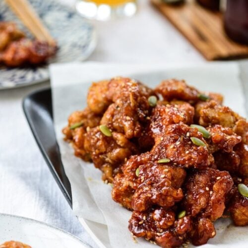 Bite sized Korean fried chicken in a sticky, sweet sauce served with beer