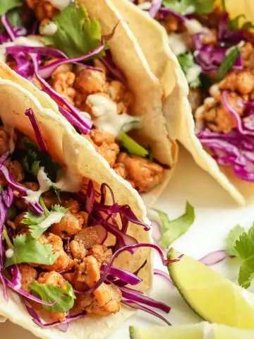 Tempeh Tacos with red cabbage slaw on a white plate