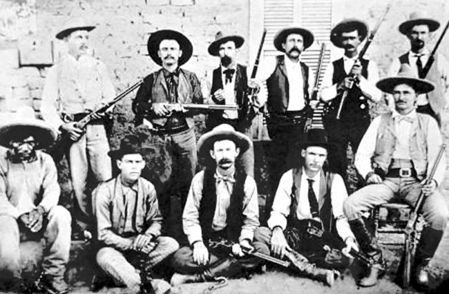 Company D of the Texas Rangers with John Hughes at lower right.