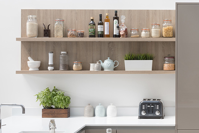 Oak shelves holding oils, fine China, cereal, pasta an house plants