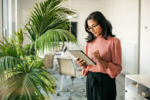 Young Indian Businesswoman Using Digital Tablet in Office