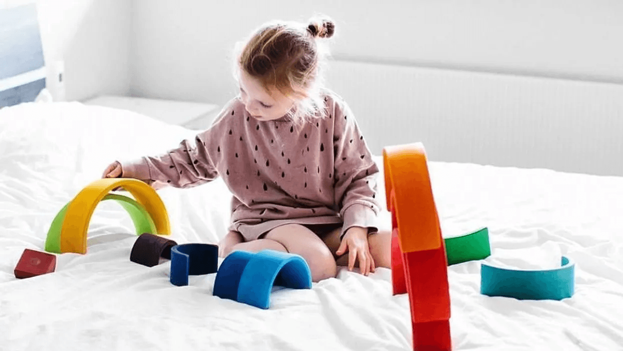 little girl playing with montessori toys