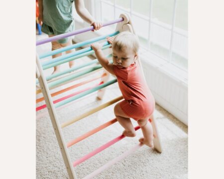 baby climbing on a Pikler triangle - Best Pikler triangles