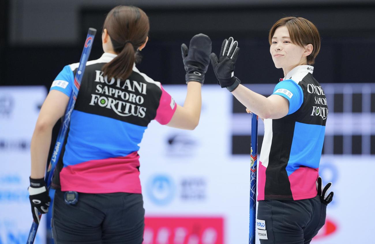 フォルティウス対北海道銀行　第4エンド、ストーンを投じ笑みを浮かべるフォルティウス小野寺（右）（撮影・垰建太）