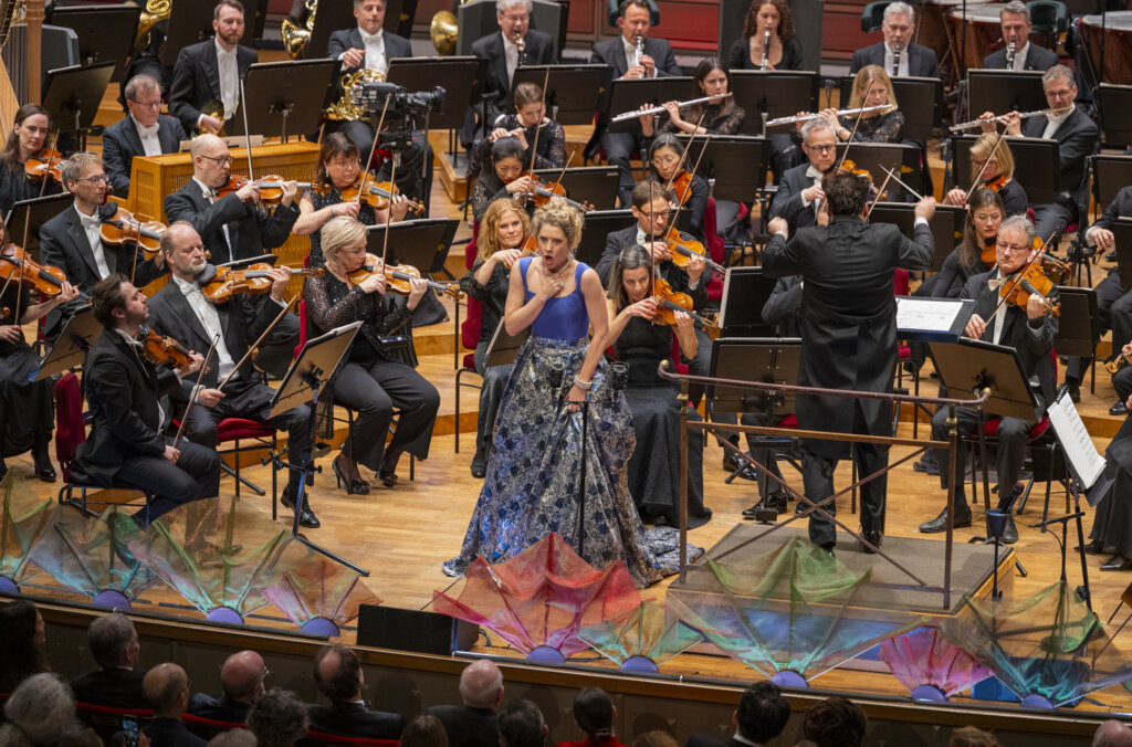 Soprano singer singing in front of orchestra