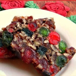 Two slices of fruit cake on a white plate.