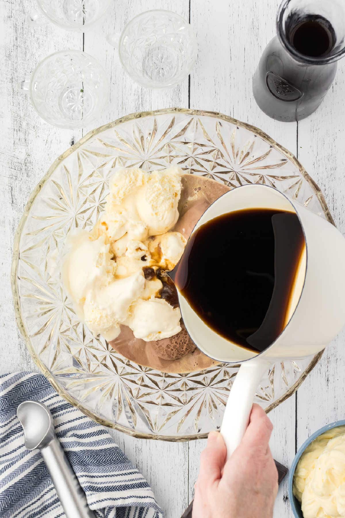 Coffee mixture being poured over ice cream.