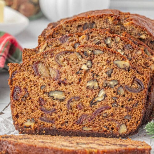 Closeup of date nut bread slices on a cutting board.