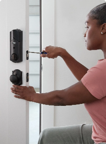 woman installing a smart lock