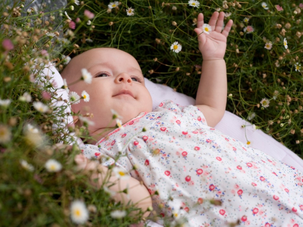 Baby lying among flowers