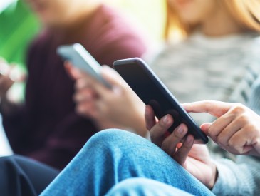 Three teens on phones