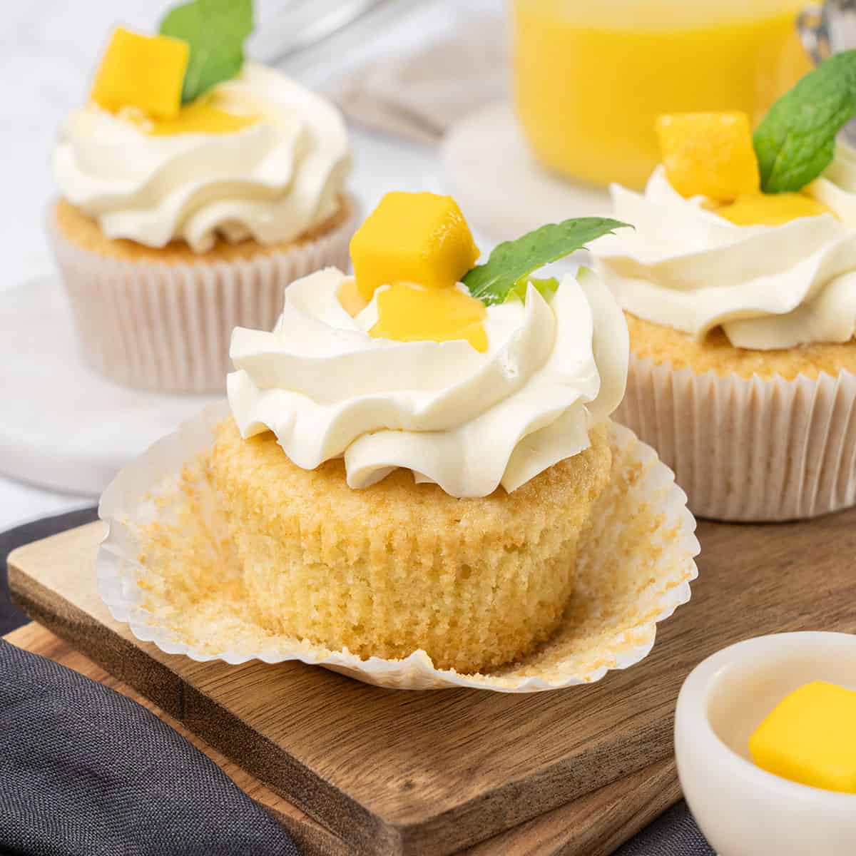 Mango cupcake on a cutting board.