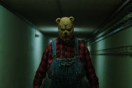 Winnie The Pooh (Ryan Olivia) walks down a long hallway in Winnie-the-Pooh: Blood & Honey 2 (2024).