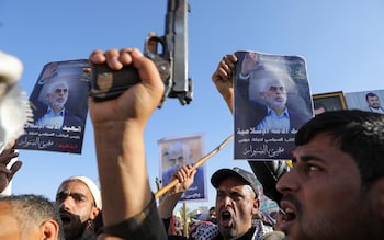 Protesters in Yemen hold posters showing the late Hamas leader Yahya Sinwar as they rally to show support to Hezbollah and Palestinians in the Gaza Strip, Oct 18