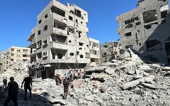 Palestinians inspect the damage after the Israeli airstrike in Beit Lahia in northern Gaza on October 19