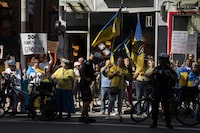 <p>People protest outside of Scotiabank Theatre about the documentary "Russians at War" playing at the Toronto International Film Festival, in Toronto, on Tuesday Sept. 10, 2024. THE CANADIAN PRESS/Paige Taylor White</p>