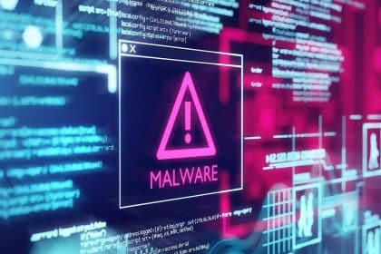 A warning sign with the word "MALWARE" on a digital screen.