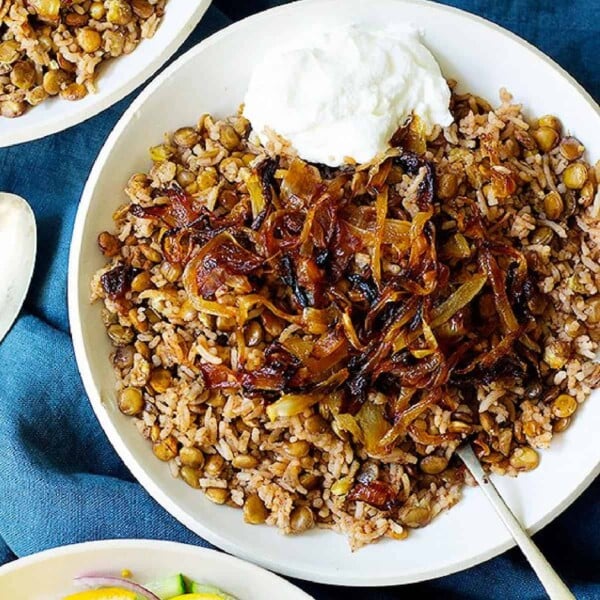 mujadara on a plate Lebanese lentil rice with some yogurt.