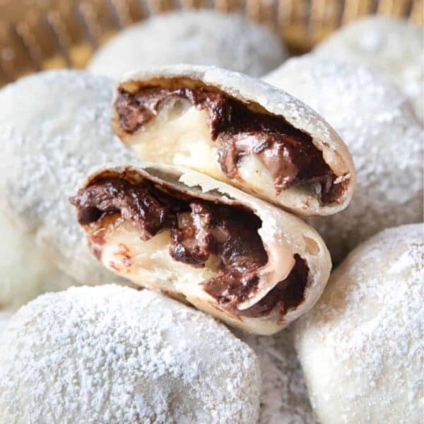 İzmir Bombası (Turkish chocolate bomb cookies) served on a golden platter with one halved on top so you can see the gooey center