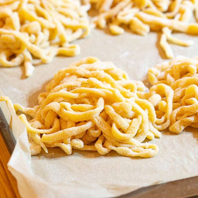 Piles of handmade pasta on a tray.